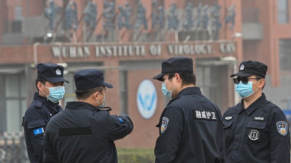 Security personnel stand guard outside the Wuhan Institute of Virology
