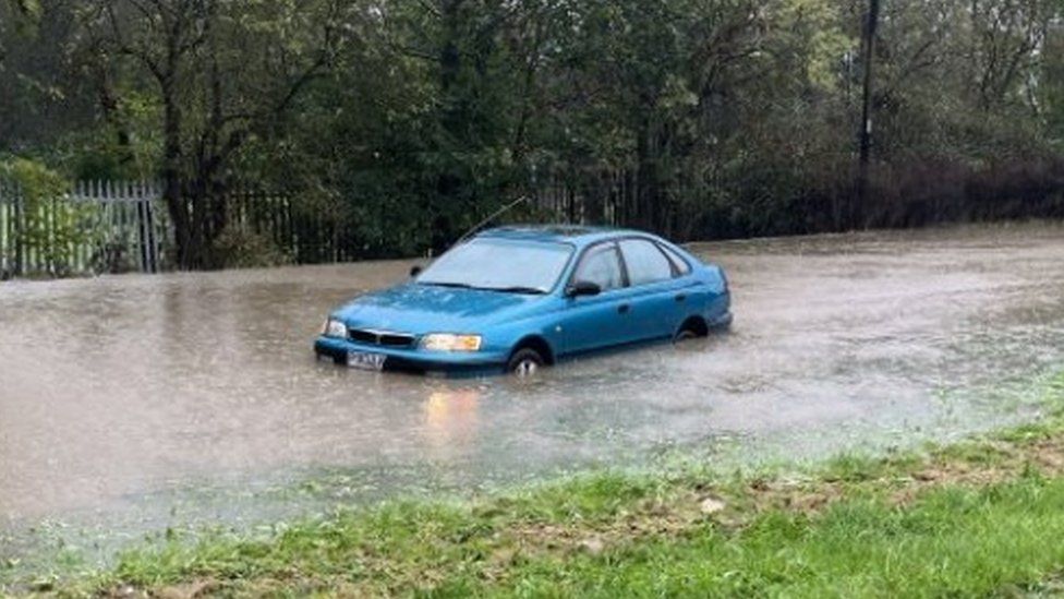 A car stuck in floodwater on Jordanthorpe Parkway, Sheffield