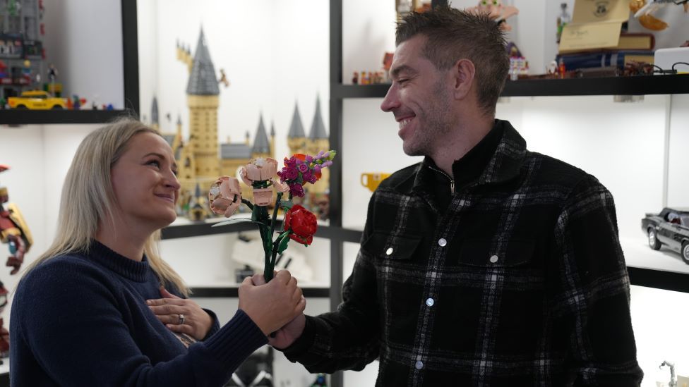 Darren Ambrose presenting Wife Rachel with Lego flowers