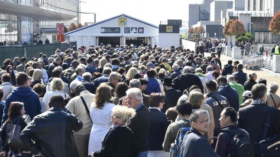 People queue outside the departure hall at Brussels airport