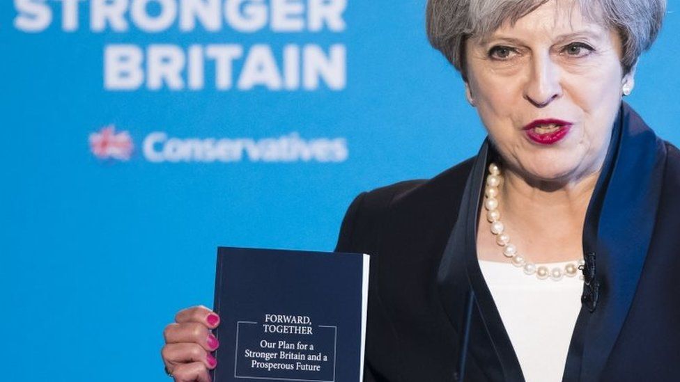 Theresa May holding the Conservative Party manifesto