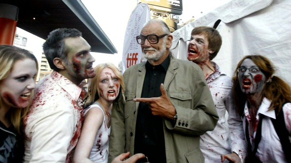 George A Romero with zombies
