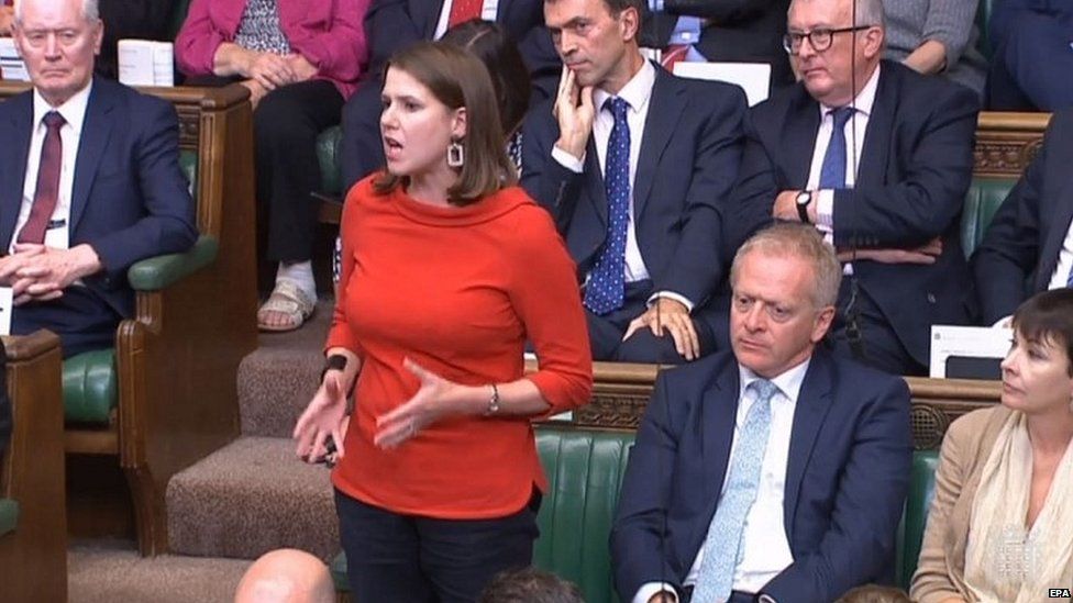 Phillip Lee sits to Liberal Democrat leader Jo Swinson as she speaks in the House of Commons