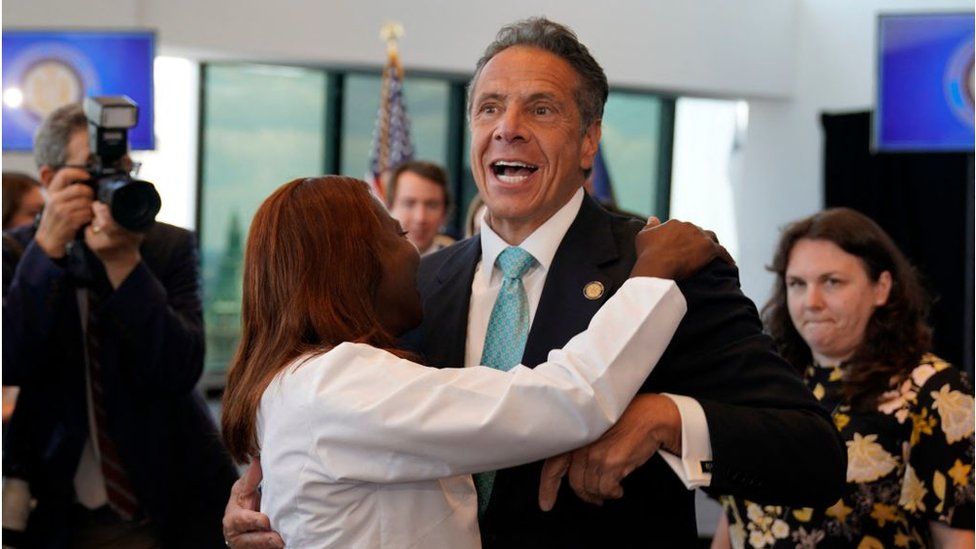 New York's governor hugs a hospital director at an event to lift 'virtually all' restrictions