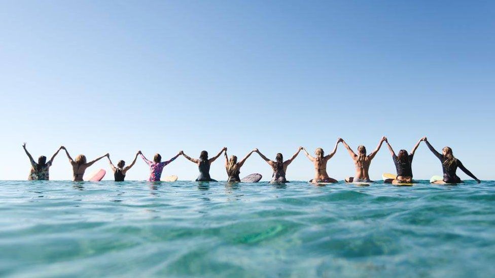 Group of women surfers