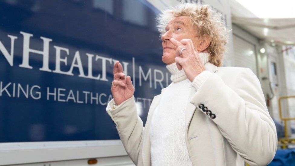 Sir Rod Stewart standing outside a mobile scanning unit