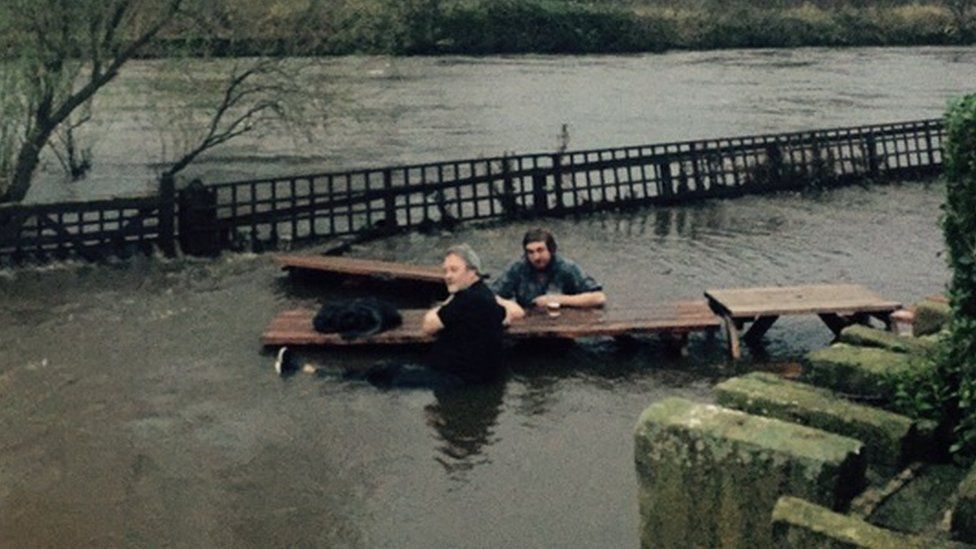 John Kelly and Steve Holt having a pint in a flooded beer garden