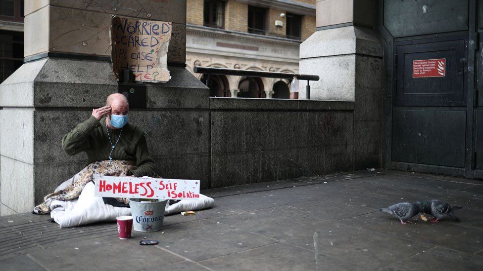 A homeless man wearing a protective face mask is seen in Westminster, as the spread of the coronavirus disease (COVID-19) continues, London, Britain