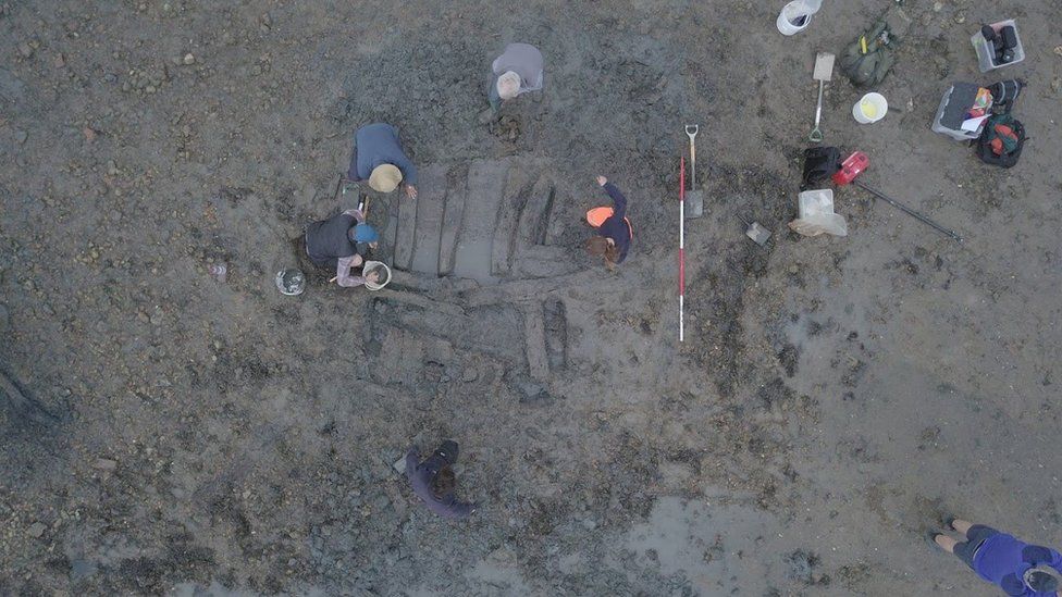 Aerial view of archaeologists digging up wreck