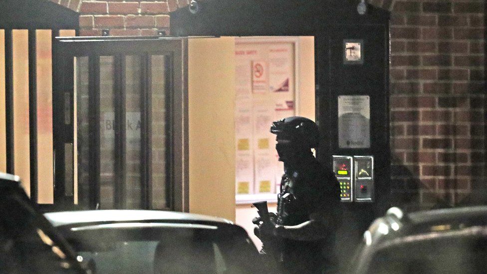 An armed police officer at a block of flats off Basingstoke Rd in Reading after an incident at Forbury Gardens in Reading town centre on 20 June 2020