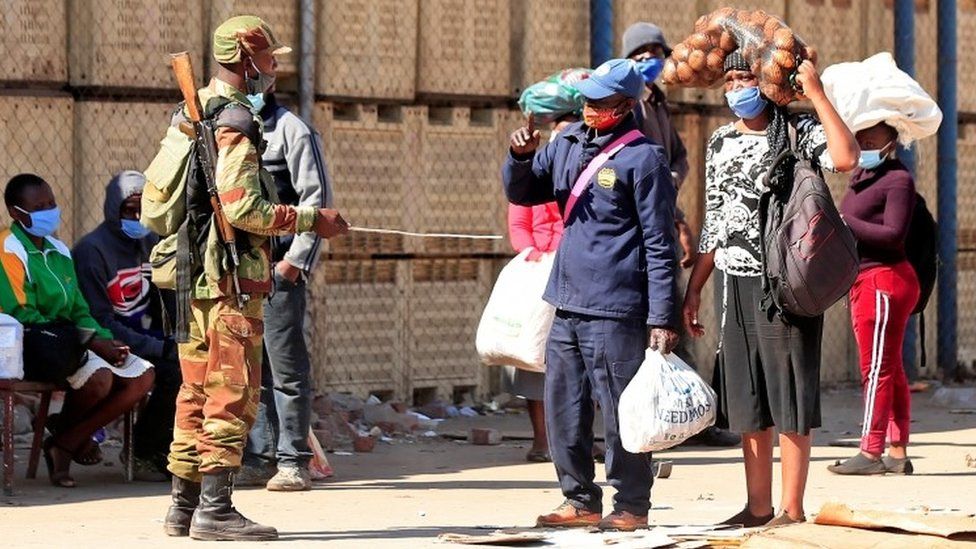 A soldier checks pedestrians ahead of planned anti-government protests during the coronavirus disease (COVID-19) outbreak in Harare, Zimbabwe, July 30, 2020