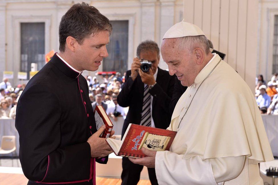 Pope Francis looking at copy of the Wimpy Kid