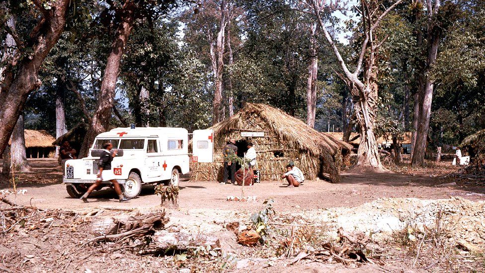 One of the project ambulances at a health post at a temporary camp on the East-West Highway at Butwal in about 1969.