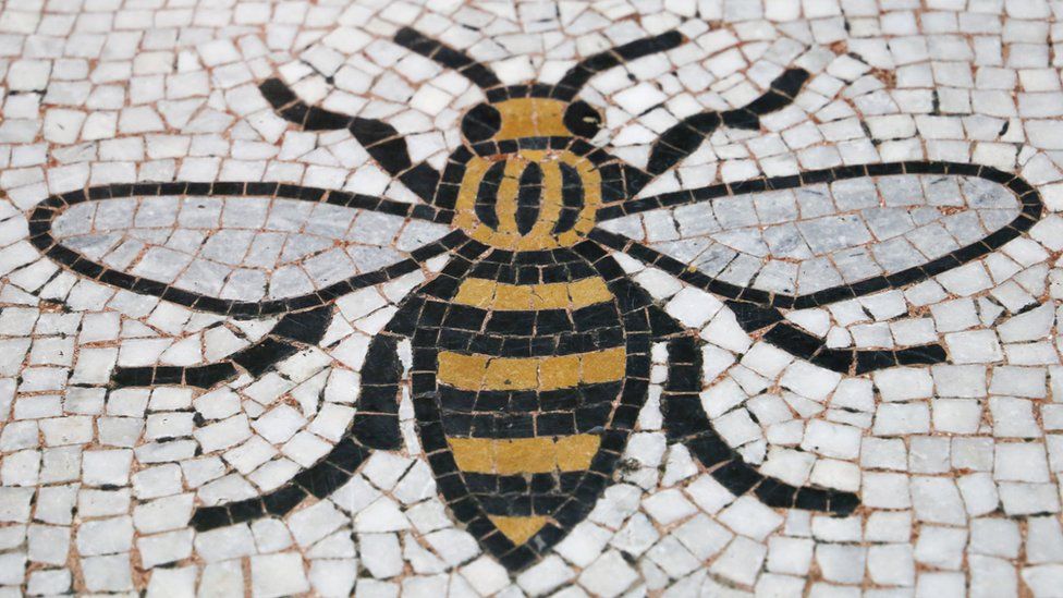 A Manchester Worker Bee incorporated into the floor of the Town Halll in Manchester.