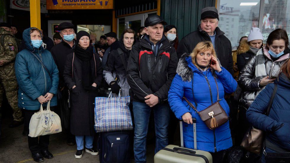 People wait for buses at a bus station as they attempt to evacuate the city on February 24, 2022 in Kyiv, Ukraine.