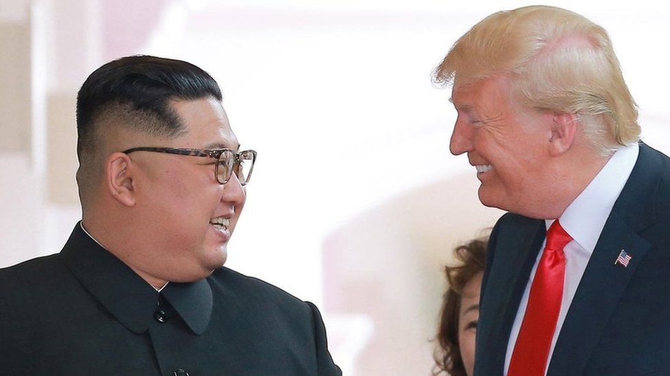 Kim Jong-un and Donald Trump smiling