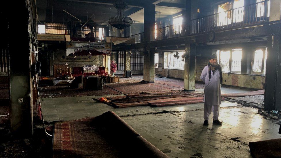 A man stands inside the ruins of the Gurdwara