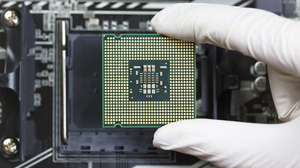 A worker slotting a processor into place