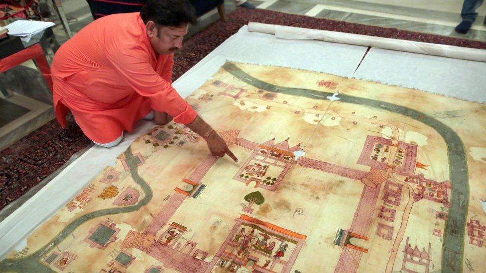 Ramu Ramdev, OSD at the City Palace, points out Lord Ramas birth place in an old dilapidated map of Ayodhya depicting the birthplace of Lord Rama, being taken out from archives of erstwhile royal family of Jaipur, at City Palace, on August 11, 2019 in Jaipur, India.