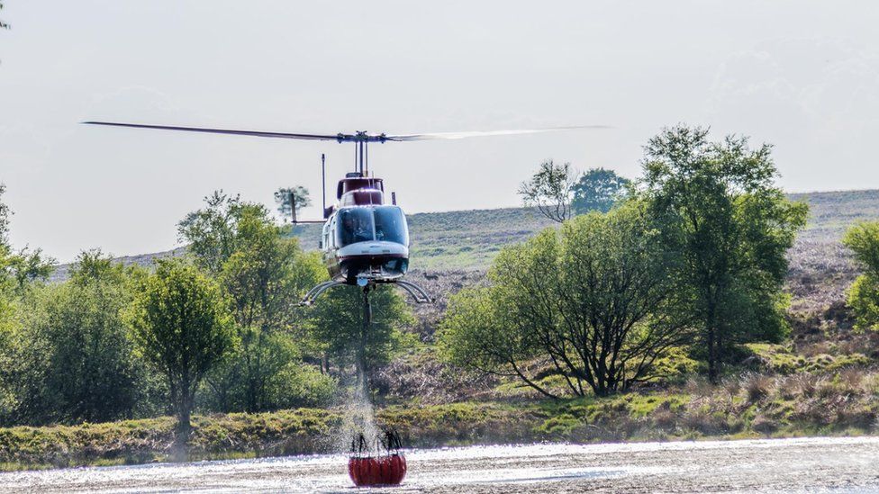 Helicopter picking up water