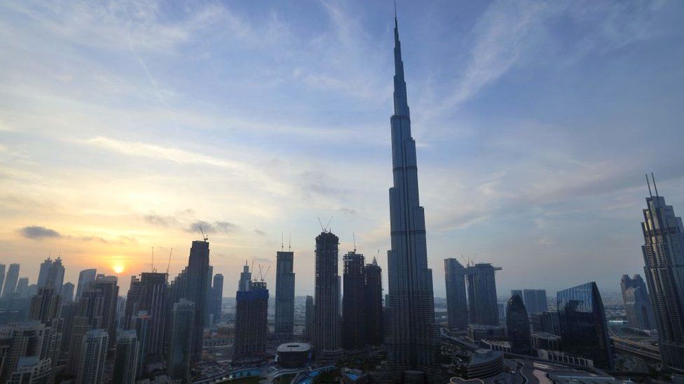 The skyline of Dubai and the high Burj Khalifa are pictured at sunset on February 9, 2021