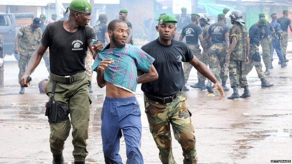 Guinean police arrest a protester during September 2009 in front of the biggest stadium in the capital Conakry during a demonstration against the military government