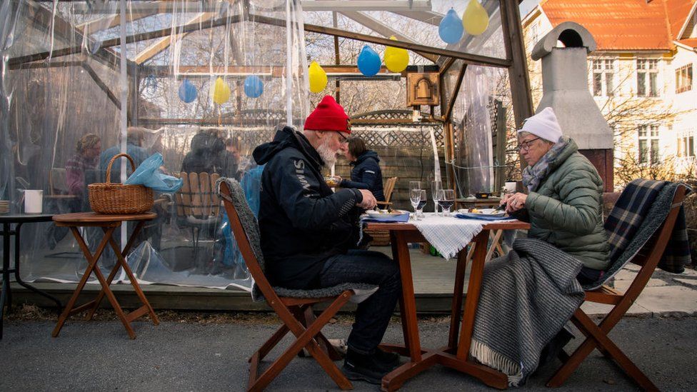 A couple eat at a cafe, 18 April 2020, in Ostersund, Sweden.