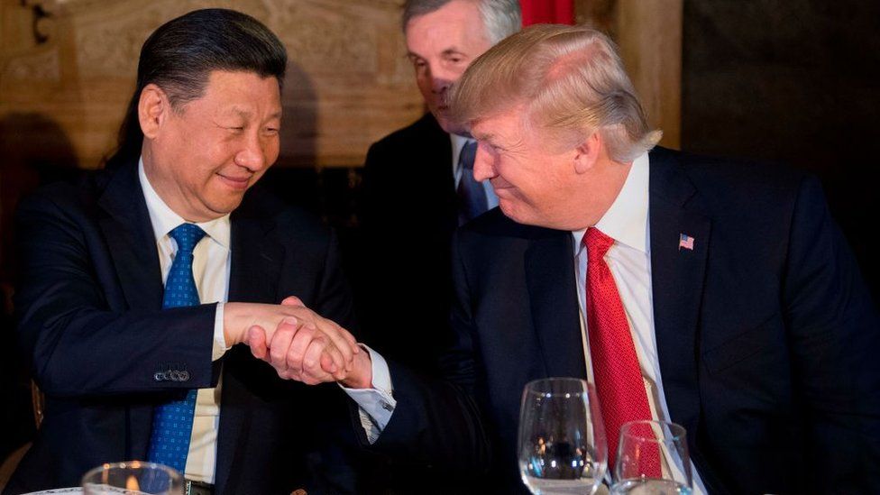 US President Donald Trump (R) and Chinese President Xi Jinping (L) shake hands during dinner at the Mar-a-Lago estate in West Palm Beach, Florida, on April 6, 2017