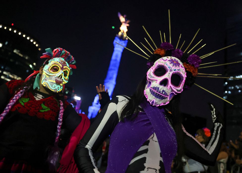 People dressed in costumes participate in the Catrinas procession as part of the celebrations for the Day of the Dead, in Mexico City, Mexico, 22 October 2023.