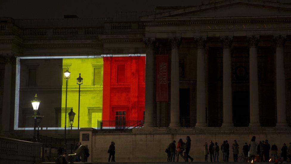 The Belgian flag is projected onto the National Gallery in London