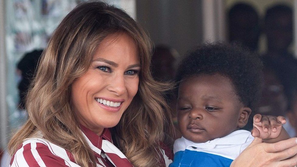 Melania Trump holds a baby in Accra, Ghana