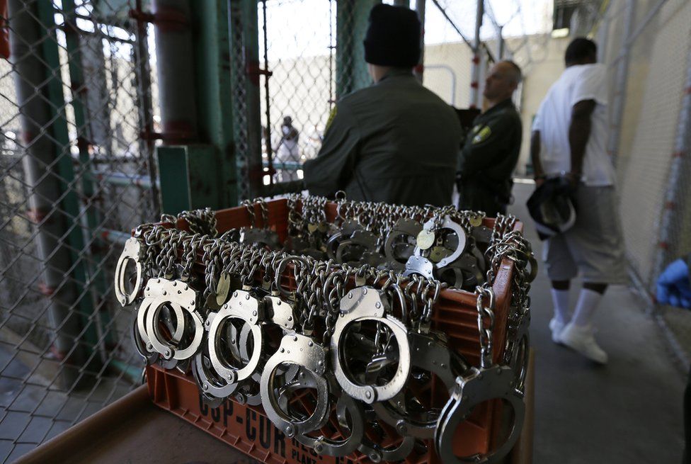 A condemned inmate walks back to his cell on death row in handcuffs after spending time in an exercise yard at San Quentin State Prison on 16 August 2016, in San Quentin, California. A pair of November ballot measures will decide the future of the death penalty in the state.