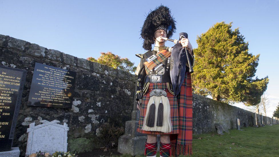 Lone piper at graveside