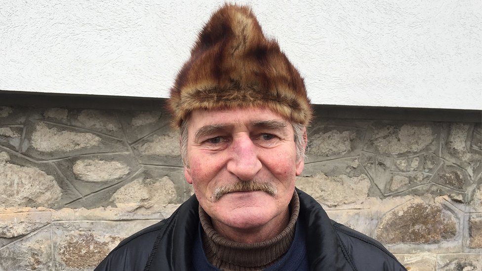 Ditrau resident Adalbert Horváth, 54, wearing a furry hat