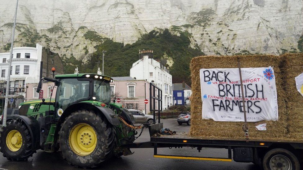 Farmers using their vehicles to protest against cheap meat imports drive past the Port of Dover in Kent