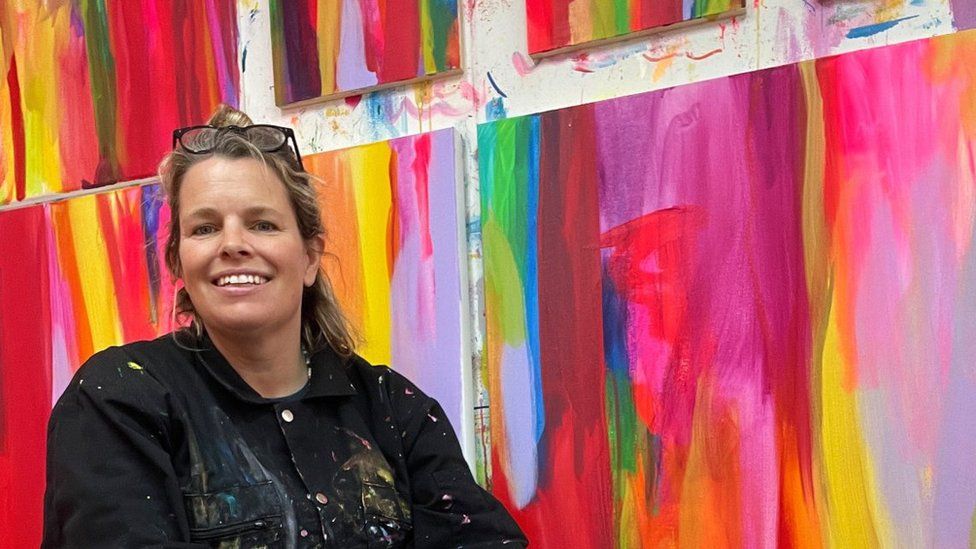 Faye Bridgwater with her paintings