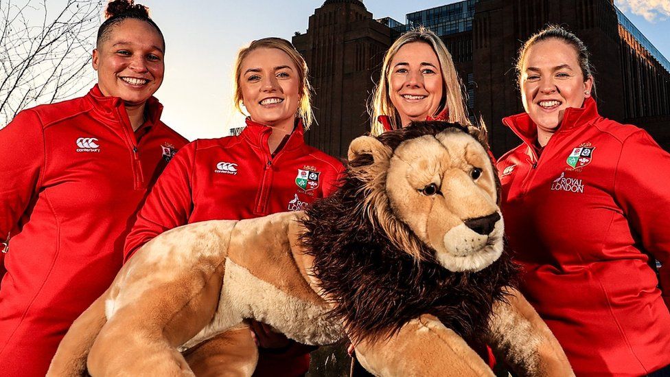 Potential British and Irish Lions players pose with a lion mascot