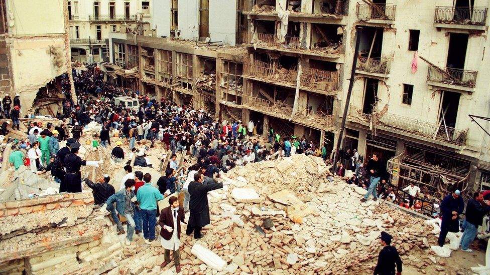 Rescue workers sift through the rubble at the site of a car-bombing at the Asociacion Mutual Israelita Argentina (AMIA) Jewish Community Center in Buenos Aires, Argentina, on July 18, 1994