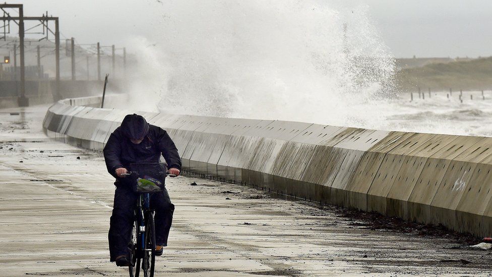 Man cycles through storm