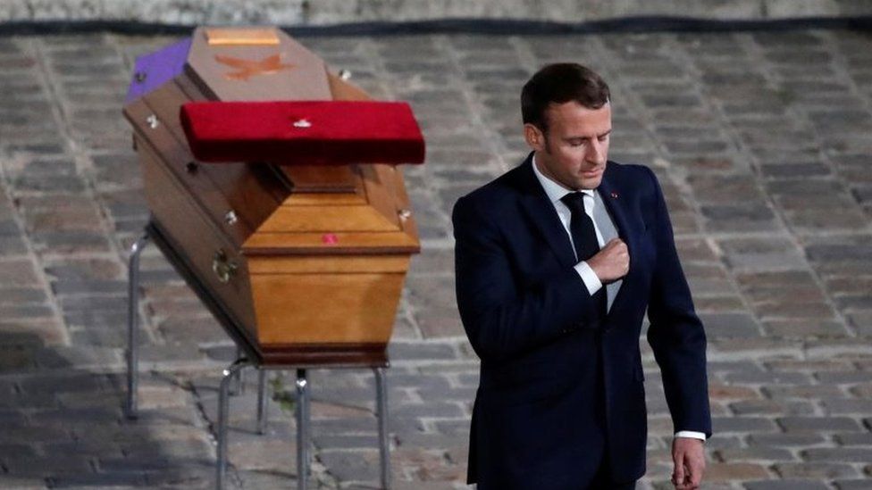 Emmanuel Macron in front of Samuel Paty's coffin