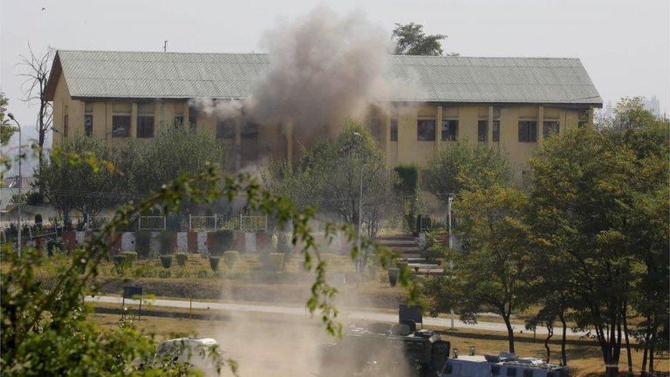 Smoke and dust rises from an Indian Border Security Force (BSF) building, that was held by suspected militants, after it was hit by explosives fired by government forces in Srinagar on October 3, 2017.