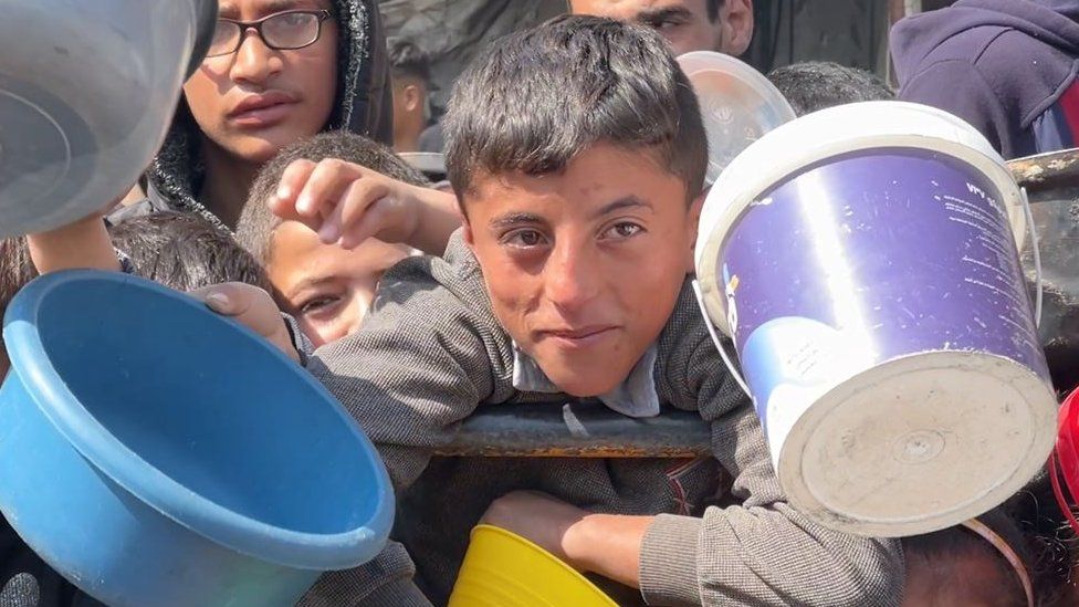 Children looking for food hold buckets