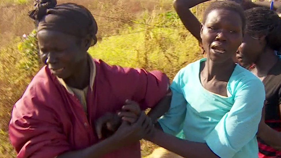 A mother (L) grieving for her son in South Sudan