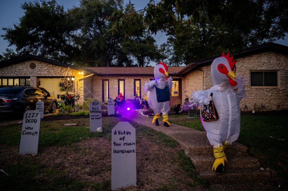 Trick-or-Treaters dressed as chickens run together in Austin, Texas