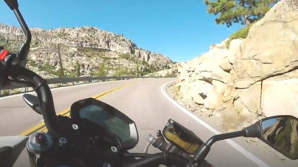 Motorbike rider's point of view of open mountain road