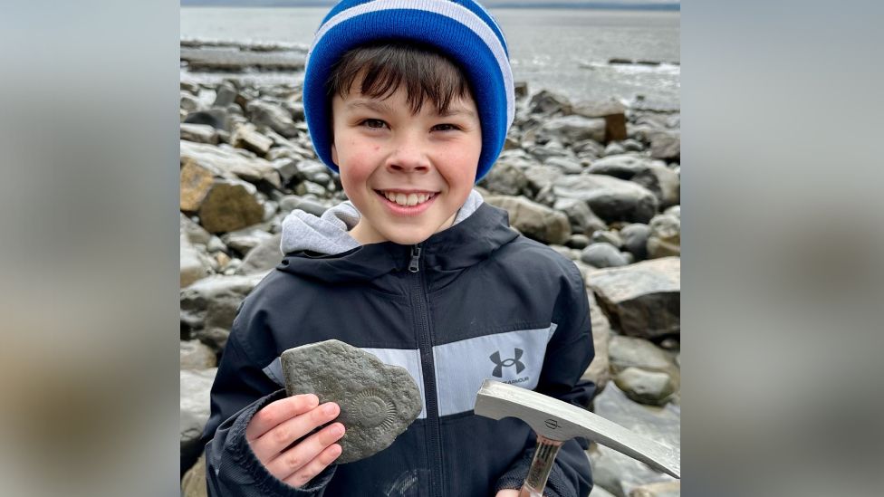 Eli holding his fossil on Llantwit Major beach