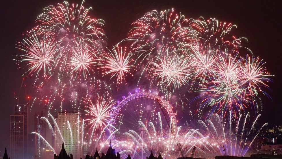 Picture showing dozens of large red fireworks explode over the London Eye