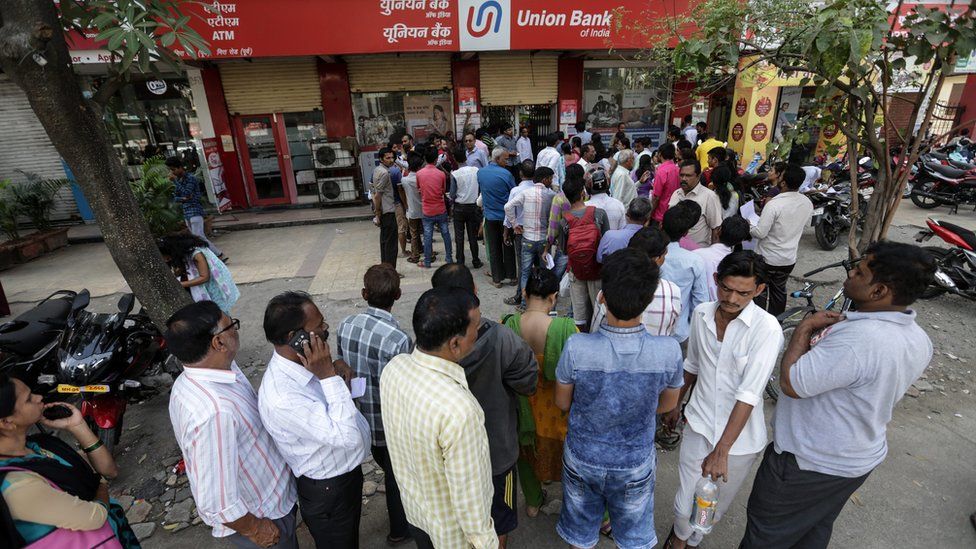 Cash for queues: people paid to stand in line amid India's bank note crisis, India