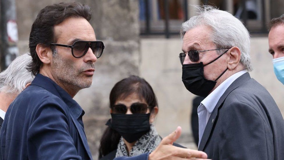 French actor Alain Delon (R), his partner and assistant Hiromi Rollin (C) and his son Anthony Delon arrive for the funeral ceremony for late French actor Jean-Paul Belmondo