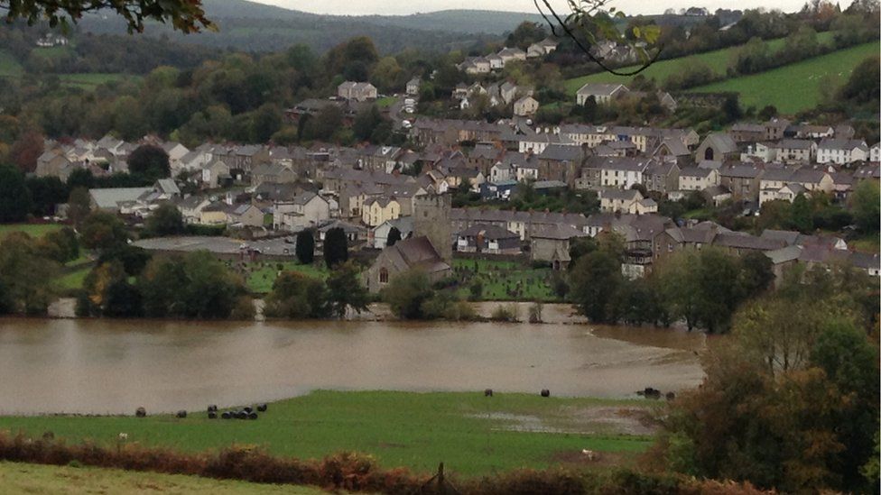 Swollen river at Llandysul, looking towards the community with the river in the foreground
